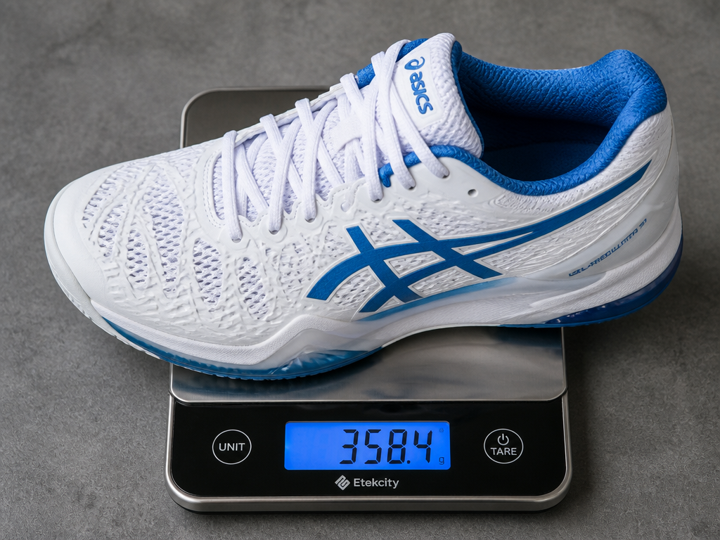 A single white-and-blue ASICS-style tennis shoe resting on a small digital kitchen scale, photographed…